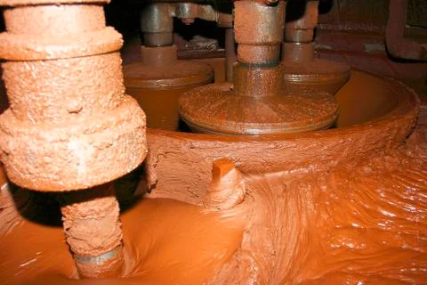 Cocoa mass tempering in the tempering machine at the chocolate factory Stock Photos