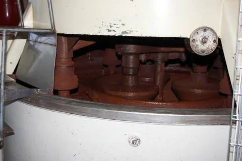 Cocoa mass tempering in the tempering machine at the chocolate factory Stock Photos