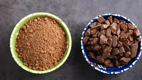 Cocoa powder and chocolate chunks on display at a kitchen counter Stock Footage 345389172