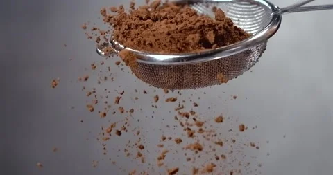 Cocoa powder falling from a sieve slow motion Stock Footage 342591172