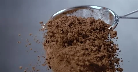 Cocoa powder falling from a sieve slow motion Stock Footage 344850052
