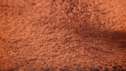 Cocoa powder falls on the table. Filmed on a high-speed camera at 1000 fps. Stock Footage 309212199
