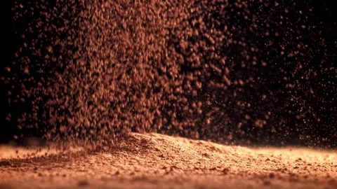 Cocoa powder falls on the table. Filmed on a high-speed camera at 1000 fps. Stock Footage 309217235