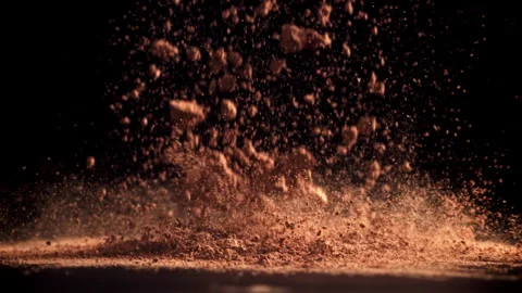 Cocoa powder falls on the table. Filmed on a high-speed camera at 1000 fps. Stock Footage 309231099