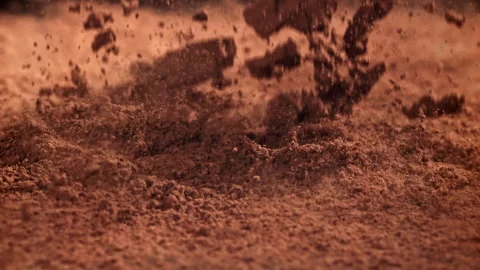 Cocoa powder falls on the table. Filmed on a high-speed camera at 1000 fps. Stock Footage 309233260
