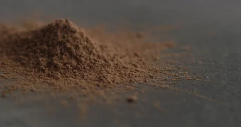 Cocoa powder is pouring onto the mountain Stock Footage 198560754