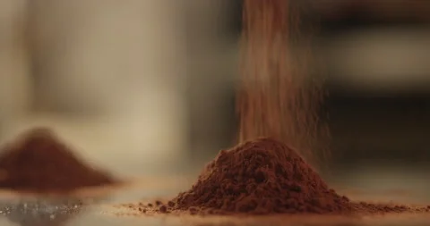 Cocoa powder is pouring onto the mountain Stock Footage 200868987