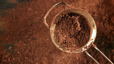 Cocoa powder is sifted through a sieve. Filmed on a high-speed camera at 1000 Stock Footage 309225281