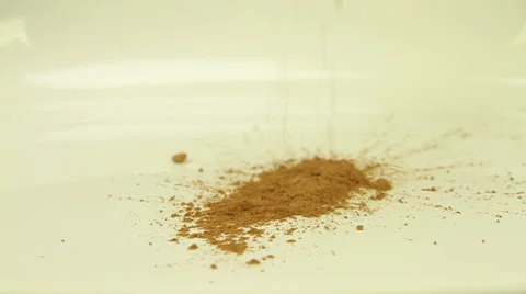 Cocoa powder sprinkled on a white surface Stock Footage 47980338