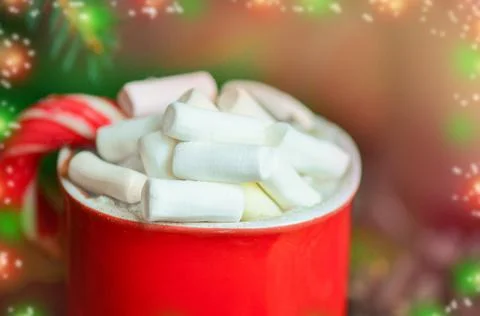 Cocoa in red mug with marshmallows. Candy cane and cocoa 스톡 사진