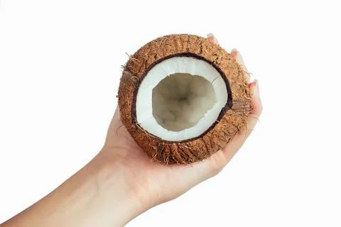 Coconut and coco nut oil in a hand on white isolate Stock Photos