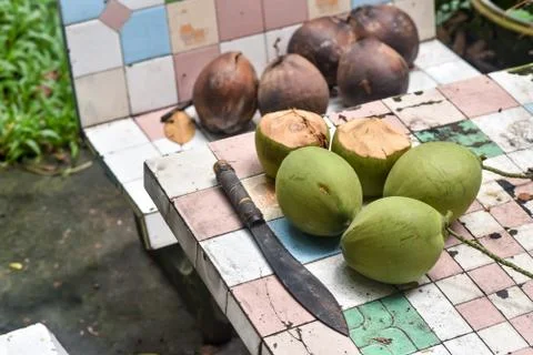 Coconut and knife on table Stock Photos