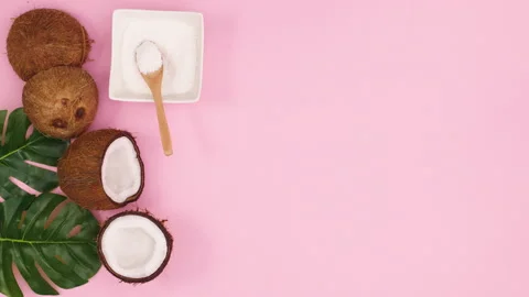 Coconut and sliced coconuts and coconut powder move on left side. Stop motion Stock Footage 147105021