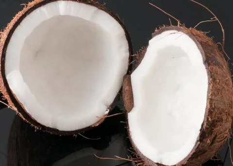 Coconut broken in half Stock Photos