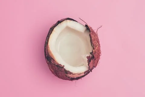 Coconut broken on pink background isolate, copyspace, layout Stock Photos