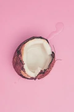 Coconut broken on pink background isolate, copyspace, layout Stock Photos