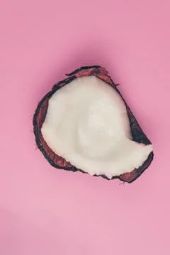 Coconut broken on pink background isolate, copyspace, layout Stock Photos