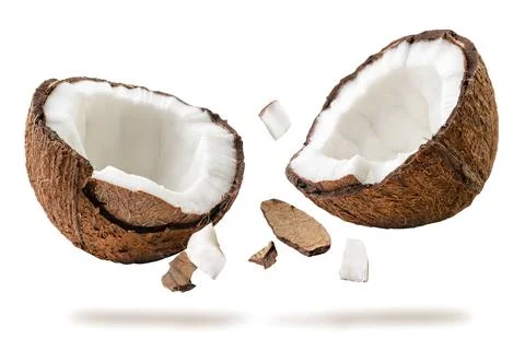 Coconut broken into two halves flies on a white. Isolated Stock Photos