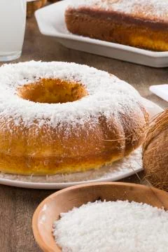 Coconut cake with slice on the table Stock Photos