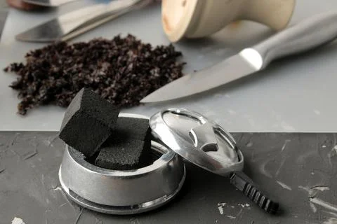 Coconut charcoal for calauda hookah close-up on a dark background and various Stock Photos