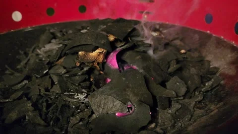 Coconut charcoal is smoldering on the griddle Stock Footage 230024528