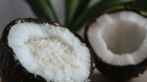 Coconut chips pouring into the coconut half Stock Footage 111672618