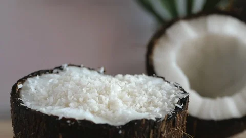 Coconut chips pouring into the coconut half Stock Footage 111672750