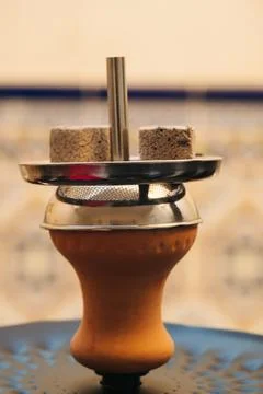 Coconut coals placed on top of a hookah bowl Stock Photos