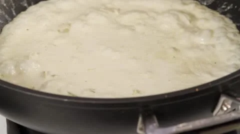 Coconut curry sauce being brought to the boil Stock Footage 24672669