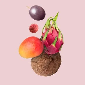 Coconut, dragonfruit, mango, lychee and maracuja in air on pink background... Stock Photos