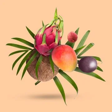 Coconut, dragonfruit, mango, lychee and maracuja falling on dark beige back.. Stock Photos