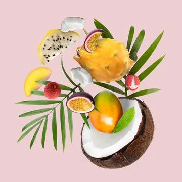 Coconut, dragonfruit, mango, lychees and maracuja in air on pink background.. Stock Photos