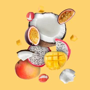 Coconut, dragonfruit, mango, lychees and maracuja in air on golden backgrou.. Stock Photos