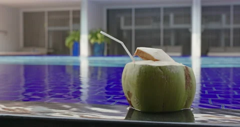 Coconut drink on swimming pool Stock Footage 131124646