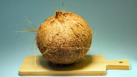 Coconut, exotic fruit, fruit in the shell on a wooden board Stock Photos