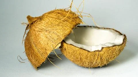 Coconut, exotic fruit, two halves of the fruit in the shell close-up Stock Photos