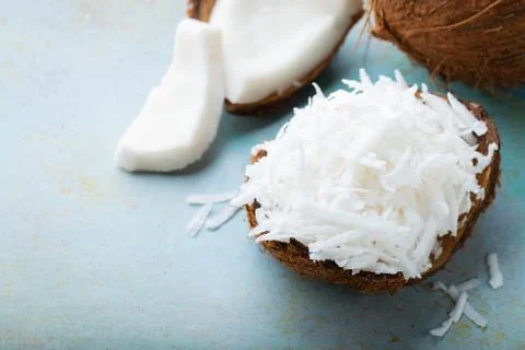 Coconut flakes in a shell on a blue background. with copy space Stock Photos