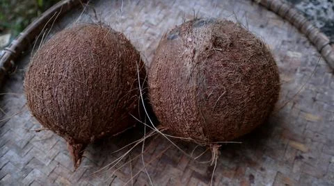 Coconut fruit that has been peeled from its skin with a mat of woven bamboo 写真素材