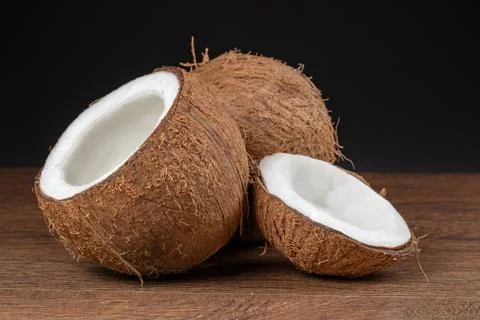 Coconut with half on dark background Stock Photos