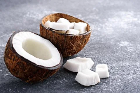 Coconut halves on grey background Stock Photos