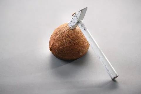 Coconut with a hammer Stock Photos