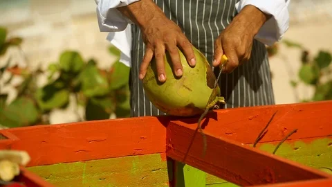 Coconut knife slicing raw green plant for juice C Stock Footage 121797331