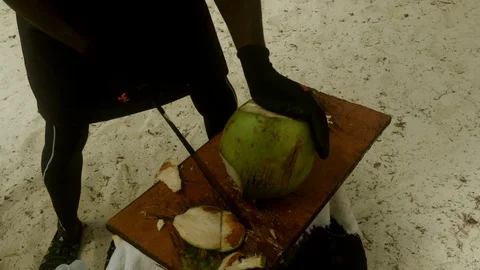 Coconut Man Chopping Fresh Coconut for Water in Lucaya, Bahamas Stock Footage 111297285