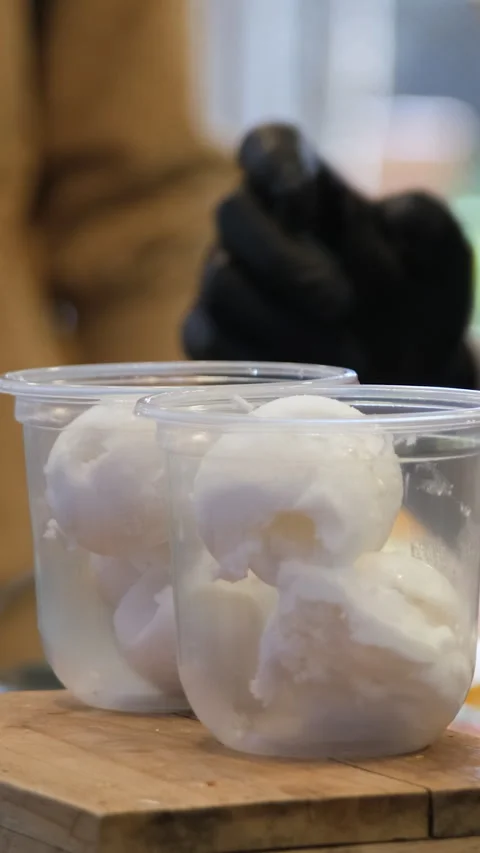 Coconut milk poured over ice cream dessert Stock Footage 345562939