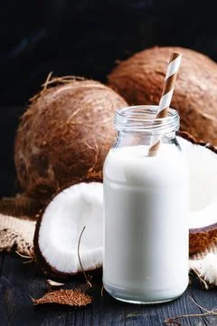 Coconut milk, rustic style, selective focus Stock Photos