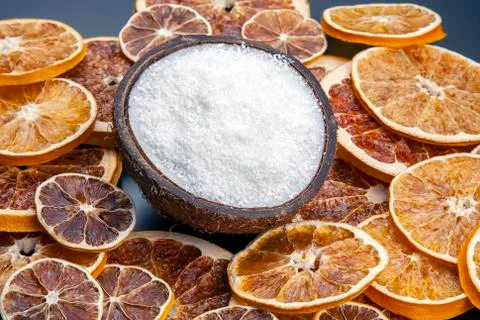 Coconut with nut chips on a background of dried citrus fruits Stock Photos