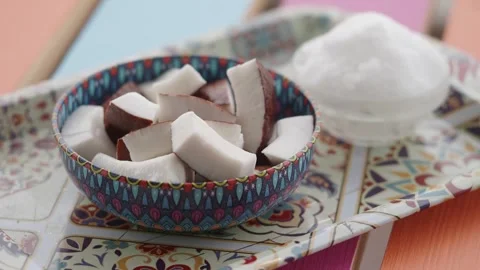 Coconut oil and slice in a container on a table Stock Footage 328783224