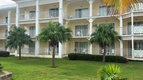 Coconut palm leaves sway in the wind on the territory of a hotel  Stock Footage 287911060