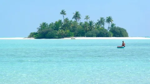 Coconut palms over a tiny, exotic island paradise with white sand beaches Video stock 106423883