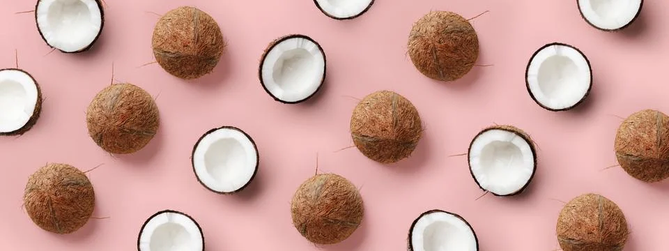 Coconut pattern on pastel pink background. Summer concept. Flat lay, top view Stock Photos